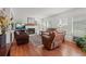 Inviting living room with a fireplace, natural light, and hardwood flooring at 2181 E Phillips Ln, Centennial, CO 80122