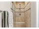 Tiled shower with glass door and built-in seat, complemented by modern fixtures at 2181 E Phillips Ln, Centennial, CO 80122