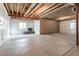 Unfinished basement with exposed wood ceiling, concrete floor, and white plastic lined walls at 1135 Basalt Ridge Loop, Castle Rock, CO 80108