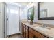 Bathroom featuring double sinks, granite countertops, wood cabinets, and glass-enclosed shower at 1135 Basalt Ridge Loop, Castle Rock, CO 80108