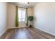 Bright bedroom featuring hardwood floors, a window with green curtains, and space for furnishings at 1135 Basalt Ridge Loop, Castle Rock, CO 80108