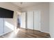 Bedroom with laminate flooring, sliding closet doors, and a wall-mounted television at 1135 Basalt Ridge Loop, Castle Rock, CO 80108