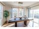 Elegant dining room with modern light fixture and sliding glass door leading to the outside at 1135 Basalt Ridge Loop, Castle Rock, CO 80108