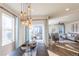 Bright dining area with a modern chandelier and a view into the living room with hardwood floors at 1135 Basalt Ridge Loop, Castle Rock, CO 80108