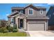 Charming two-story home with a stone-accented entrance and a well-manicured front yard at 1135 Basalt Ridge Loop, Castle Rock, CO 80108