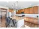 Modern kitchen with granite countertops, stainless steel appliances, and a center island with bar stools at 1135 Basalt Ridge Loop, Castle Rock, CO 80108