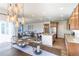 Open-concept kitchen featuring stainless steel appliances, an island with bar seating, and modern hanging lights at 1135 Basalt Ridge Loop, Castle Rock, CO 80108