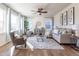Cozy living room with large windows, a ceiling fan, and comfortable seating arrangement at 1135 Basalt Ridge Loop, Castle Rock, CO 80108