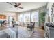 Spacious living area with hardwood floors and natural light, seamlessly connected to the dining area at 1135 Basalt Ridge Loop, Castle Rock, CO 80108