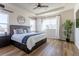 Spacious main bedroom featuring a tray ceiling, large windows, and luxury vinyl plank flooring at 1135 Basalt Ridge Loop, Castle Rock, CO 80108