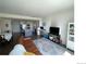 Spacious open-concept living area with a modern kitchen, comfortable seating, and stylish decor at 9637 E 56Th Pl, Denver, CO 80238