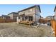 View of back of the house and patio in a fenced backyard with a grill at 25126 E Bayaud Pl, Aurora, CO 80018