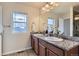 Bright bathroom featuring granite countertops, double sinks, and decorative vanity lighting at 25126 E Bayaud Pl, Aurora, CO 80018