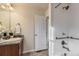 Bright bathroom featuring a single vanity sink, granite counters and a tiled shower at 25126 E Bayaud Pl, Aurora, CO 80018