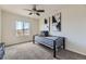 Well-lit bedroom with neutral walls, ceiling fan, carpeted floor, and large window view at 25126 E Bayaud Pl, Aurora, CO 80018