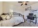 Bright bedroom features a metal-frame daybed with plush pillows and a ceiling fan at 25126 E Bayaud Pl, Aurora, CO 80018