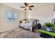 Cozy bedroom featuring a carpeted floor, ceiling fan, and a window with blinds at 25126 E Bayaud Pl, Aurora, CO 80018