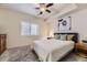 Well-lit carpeted bedroom features neutral walls, ceiling fan, and bedside tables at 25126 E Bayaud Pl, Aurora, CO 80018