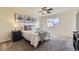 Bright bedroom features a ceiling fan, neutral walls, carpeted floor, and decorative art at 25126 E Bayaud Pl, Aurora, CO 80018