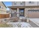 Charming front entrance with a covered porch, stone accents, and manicured landscaping at 25126 E Bayaud Pl, Aurora, CO 80018