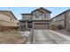 Inviting two-story home with a two-car garage, stone accents, and a well-manicured front yard at 25126 E Bayaud Pl, Aurora, CO 80018