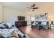 Cozy living room with hardwood floors, stylish furnishings, and a modern ceiling fan at 25126 E Bayaud Pl, Aurora, CO 80018