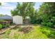 Large backyard with a storage shed, flowers, green lawn and wooden fence at 4616 E Yale Ave, Denver, CO 80222