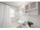 Clean white bathroom featuring a shower with curtain, tile walls and a sink at 4616 E Yale Ave, Denver, CO 80222