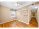 Bright bedroom with hardwood floors, large window, and access to hallway at 4616 E Yale Ave, Denver, CO 80222