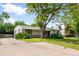Ranch style home with mature landscaping and lawn and a concrete driveway at 4616 E Yale Ave, Denver, CO 80222