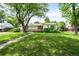 Charming ranch-style home featuring a spacious front yard with mature tree coverage at 4616 E Yale Ave, Denver, CO 80222