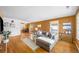 Spacious living room with a dining table and large windows, showcasing hardwood floors at 4616 E Yale Ave, Denver, CO 80222