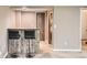 Charming basement bar area with wood paneling and seating for two at 8795 W Cornell Ave # 1, Lakewood, CO 80227