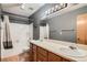 Renovated bathroom with an expanded vanity, double sinks, and large mirror at 8795 W Cornell Ave # 1, Lakewood, CO 80227