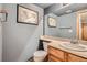 Stylish bathroom with a framed map above the toilet and large framed mirror above the sink at 8795 W Cornell Ave # 1, Lakewood, CO 80227