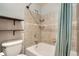 Shower and tub combination with shower curtain and mounted racks in renovated bathroom at 8795 W Cornell Ave # 1, Lakewood, CO 80227