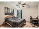 Bedroom includes a ceiling fan, window, and a desk for home office convenience at 8795 W Cornell Ave # 1, Lakewood, CO 80227