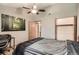Bedroom features a ceiling fan, walk-in closet, and adjacent door to the bathroom at 8795 W Cornell Ave # 1, Lakewood, CO 80227