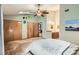Spacious bedroom featuring a ceiling fan, three closets, and an adjacent bathroom area at 8795 W Cornell Ave # 1, Lakewood, CO 80227