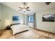 Cozy bedroom featuring neutral walls, a ceiling fan, and ample natural light from the window at 8795 W Cornell Ave # 1, Lakewood, CO 80227