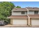 Townhome exterior with an attached garage, brown roof, and gray siding at 8795 W Cornell Ave # 1, Lakewood, CO 80227