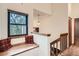 Bright hallway with window bench and natural light; features wood banister and a decorative pendant light at 8795 W Cornell Ave # 1, Lakewood, CO 80227