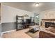 Cozy living room with a stone fireplace, wood flooring, and display shelving at 8795 W Cornell Ave # 1, Lakewood, CO 80227