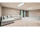 Spacious living room features a comfortable gray couch and sliding door access to the outside at 8795 W Cornell Ave # 1, Lakewood, CO 80227