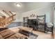 Open floor plan showcasing the stairs, TV, display shelves, and seating at 8795 W Cornell Ave # 1, Lakewood, CO 80227