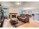 Living room featuring a stone fireplace, wood floors, and a comfortable brown sofa at 8795 W Cornell Ave # 1, Lakewood, CO 80227