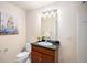 Cozy bathroom with a granite countertop, a decorative painting and a tiled shower at 4875 S Monaco St # 105, Denver, CO 80237