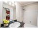 Bathroom features a granite countertop vanity and a tub with shower at 4875 S Monaco St # 105, Denver, CO 80237