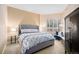 Comfortable bedroom featuring a plush bed, window with shutters, and stylish decor at 4875 S Monaco St # 105, Denver, CO 80237