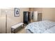 Serene bedroom featuring a plush bed, bench, and stylish decor at 4875 S Monaco St # 105, Denver, CO 80237